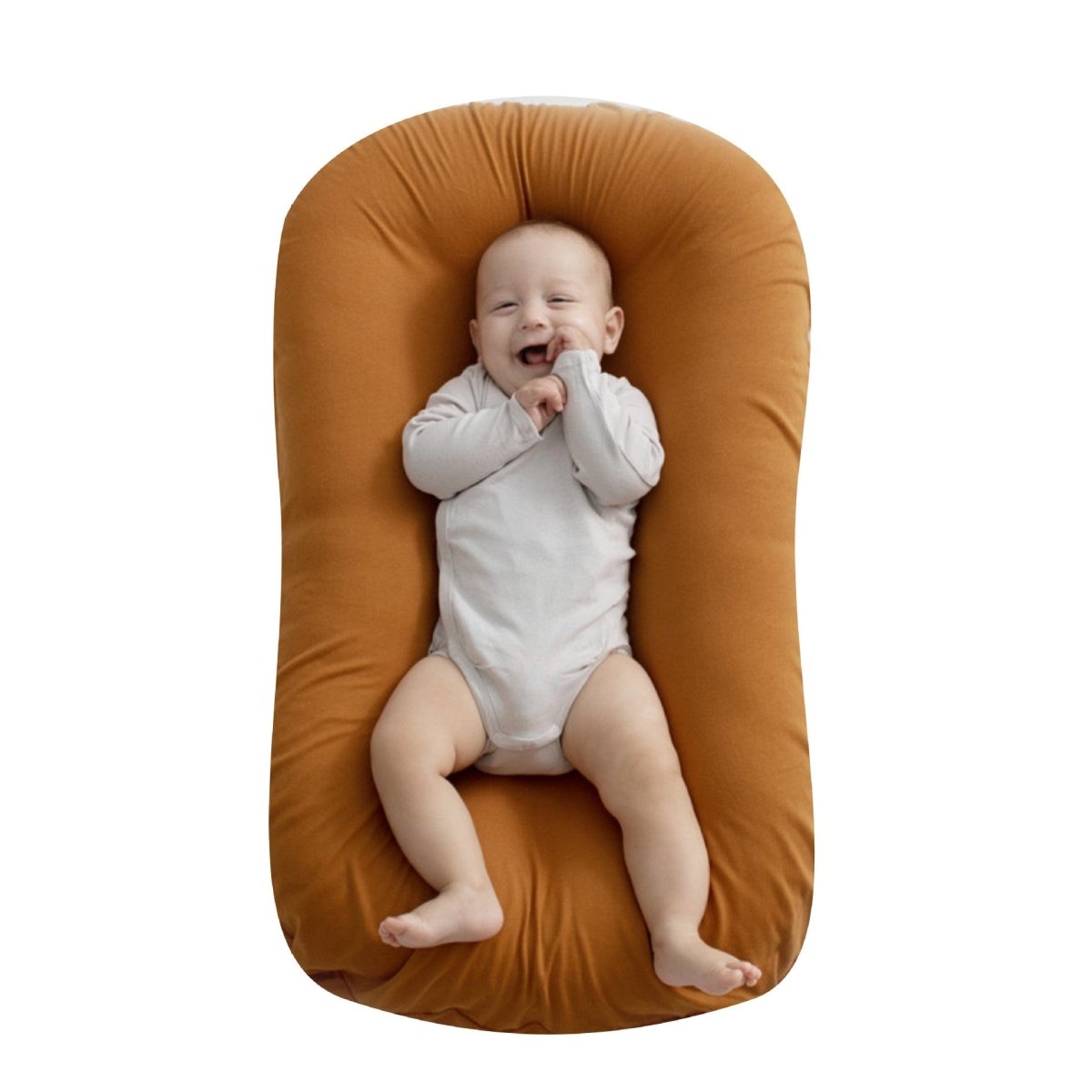 Baby nest bed for newborns in orange cotton, portable travel cradle cushion.
