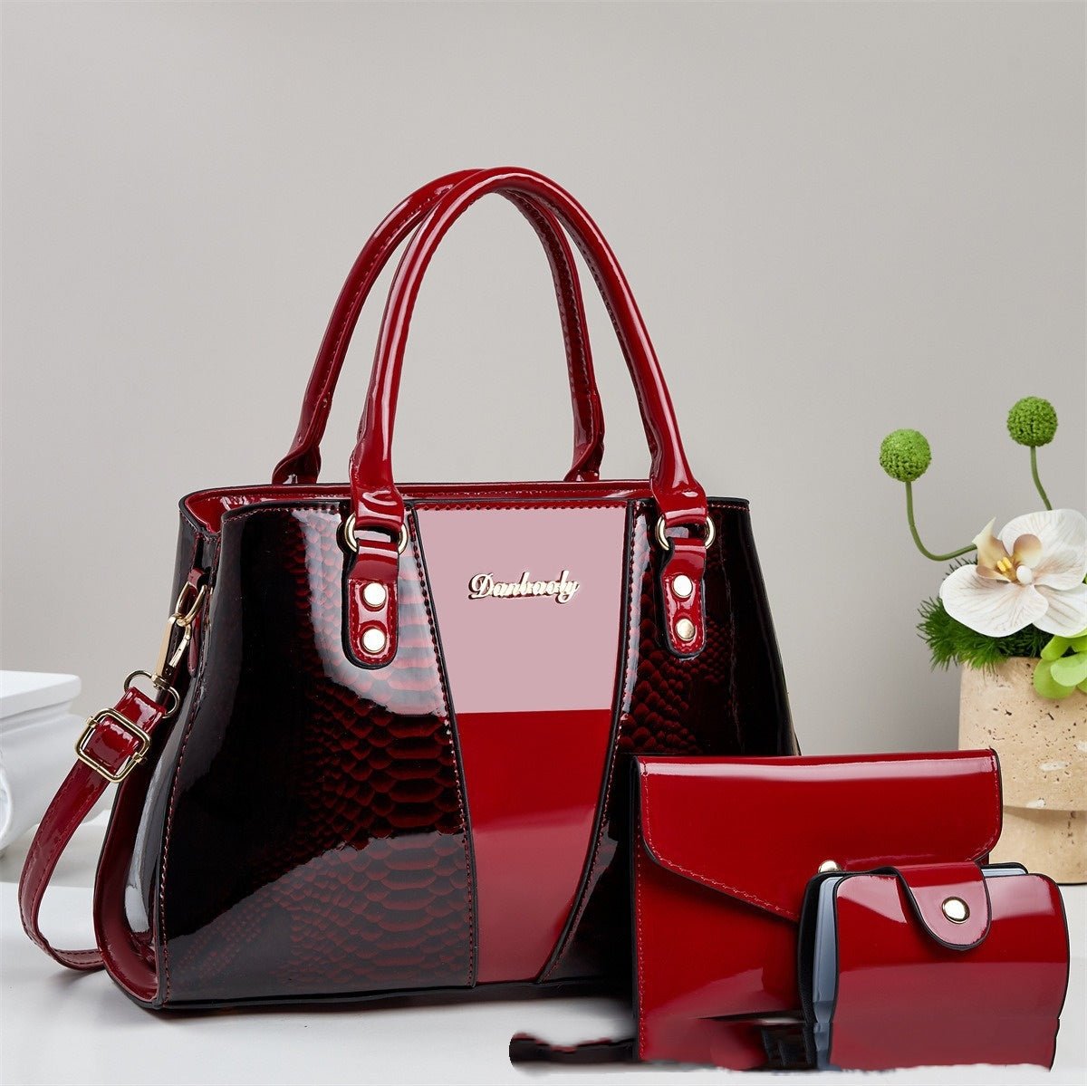 Large-capacity snakeskin-pattern tote bag with red glossy finish; includes matching wallet and cardholder.