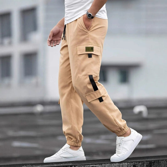 Men's beige Ancient Energy retro jogger casual work pants with cargo pocket, flap, black strap and elastic cuffs.