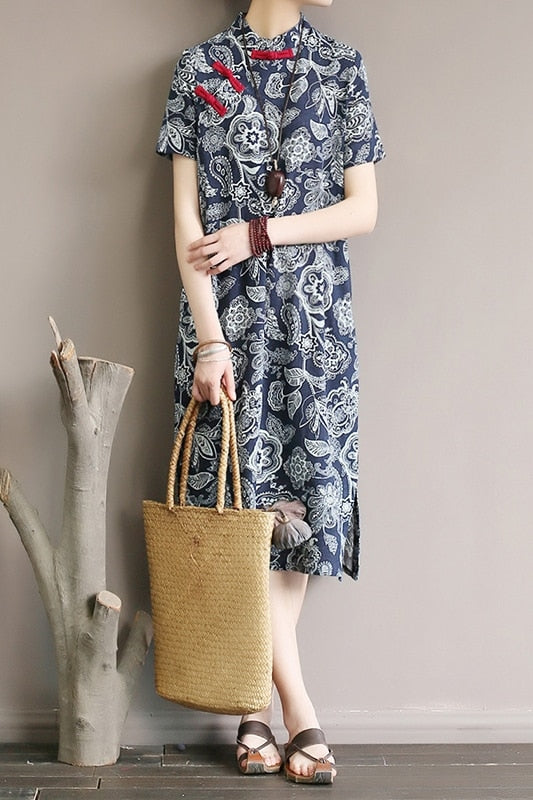 Mandotos International retro floral cotton dress with side slit, featuring a vibrant floral pattern and flowing silhouette.