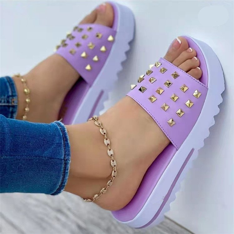 Women's pair of wedge rivet beach flip-flops in lavender purple by Ancient Energy, with gold studded straps