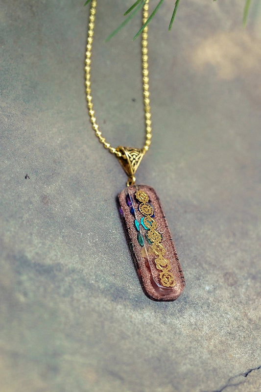 7 chakra Orgone copper pendant with chain from Ancient Energy, featuring colorful chakra stones and intricate metalwork.