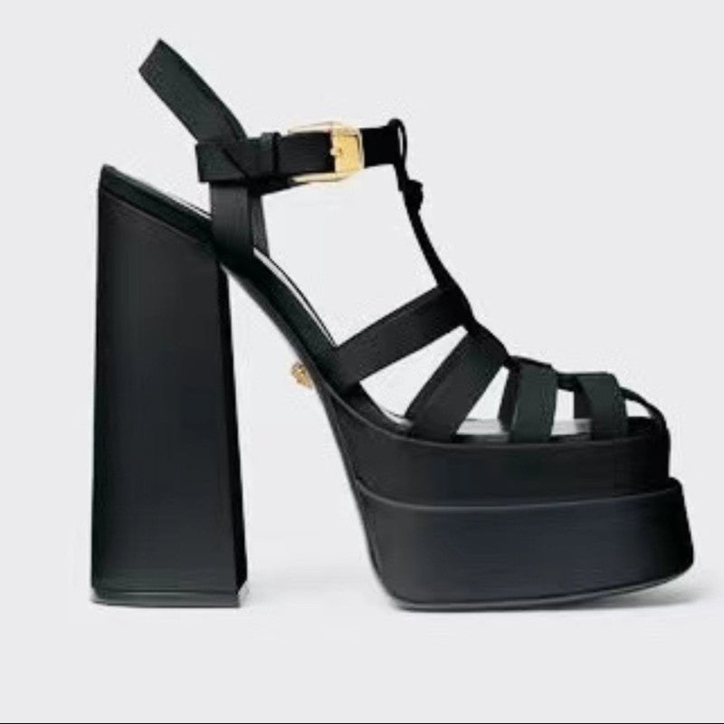 Black platform sandals by Ancient Energy with chunky heel, strappy fish-mouth design and gold buckle.