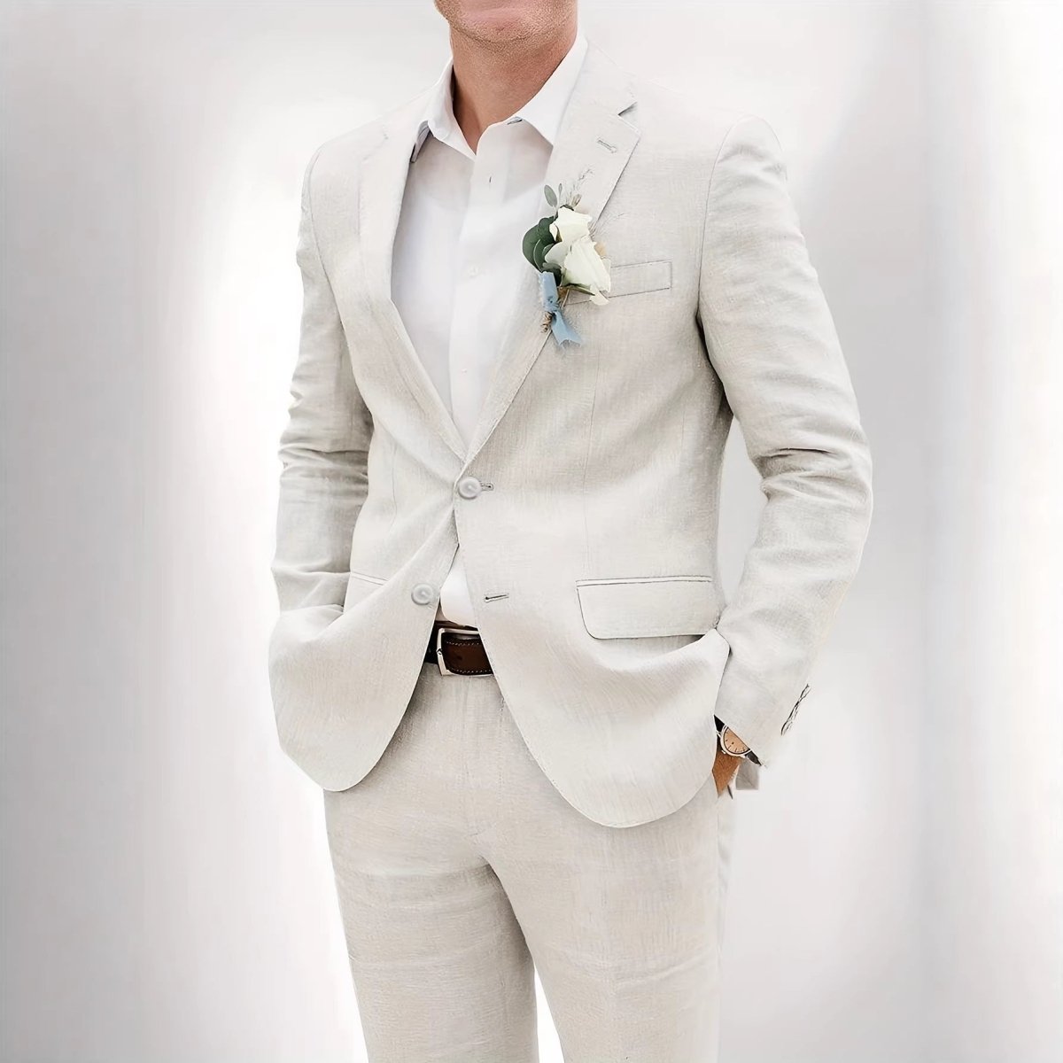 Mens beige linen suit with white shirt and boutonniere, two-button jacket, matching trousers.
