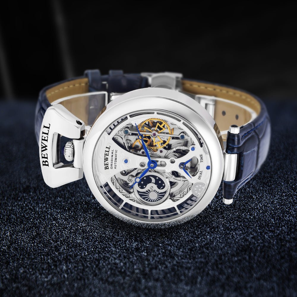 Mens skeleton watch with blue leather strap and silver case; Bewell branding visible.