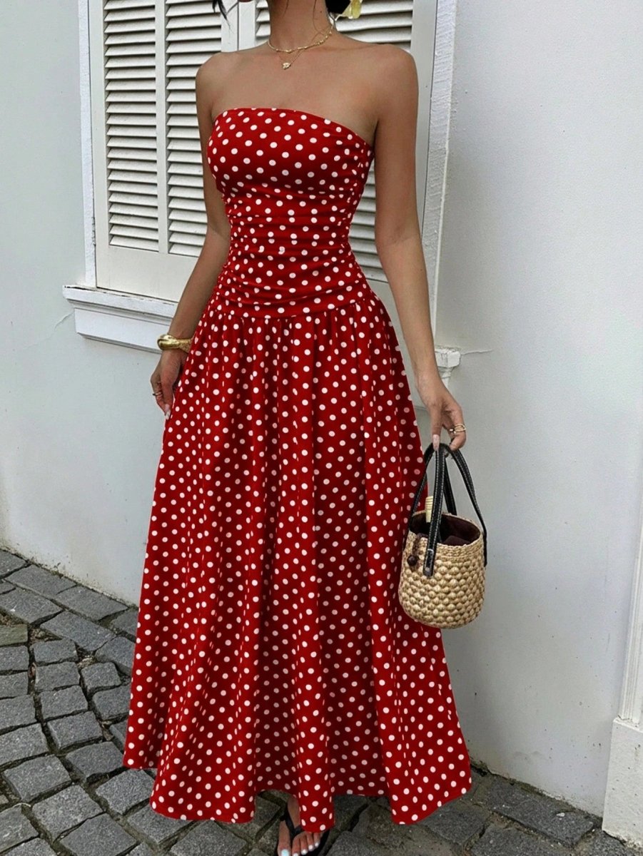 Red polka-dot strapless maxi dress with a fitted bodice and flowing skirt