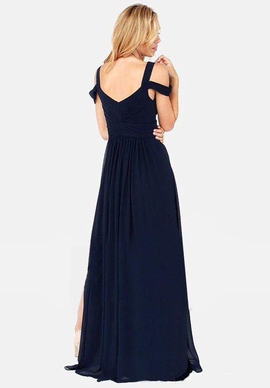Long floor-length elegant Greek style pleated dress by MANDOTOS, featuring flowing fabric and sophisticated design.