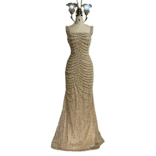 Nude elegant sling dress by MANDOTOS featuring light luxury design with pearl beaded accents and high-end style.