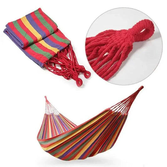 Mandotos Adventure Ready Hammock hanging between trees with a person relaxing outdoors in natural setting.