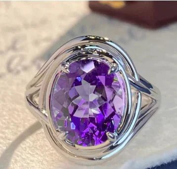 Elegant amethyst copper ring by MANDOTOS featuring a polished purple gemstone and intricate copper band design.
