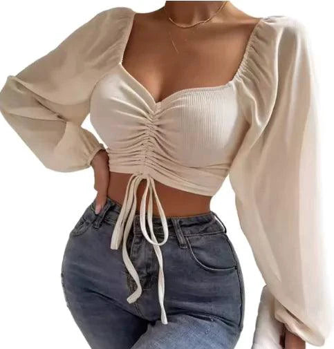 Mandotos chic v-neck balloon sleeve crop top shown on a model, featuring stylish design and lightweight fabric.