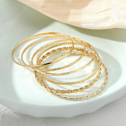 Six-piece MANDOTOS Bohemian metal chain bracelet set for women featuring geometric gold-colored thick link bangles.