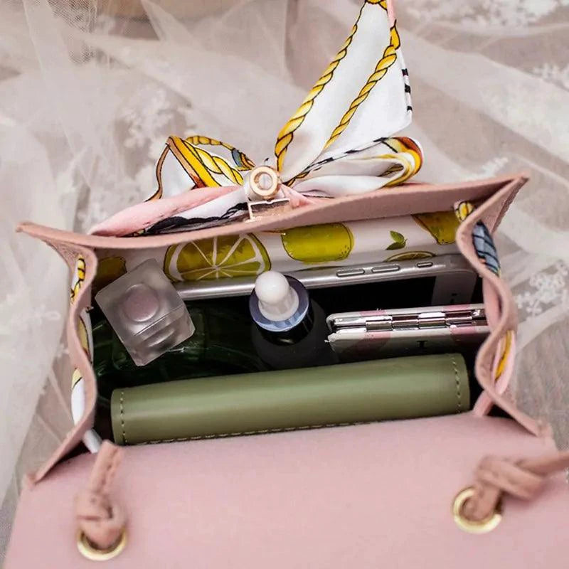 Elegant leather handbag and matching scarf by MANDOTOS, featuring stylish design and premium craftsmanship.