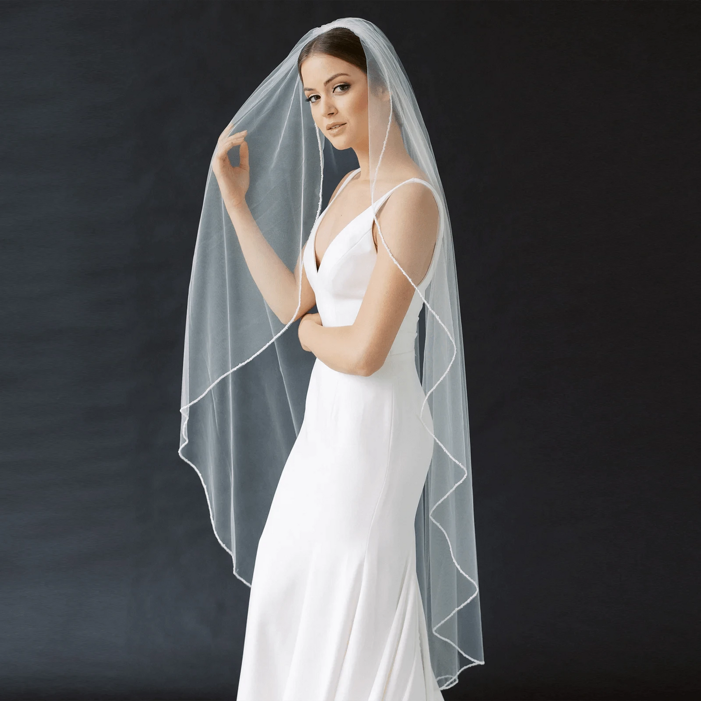 Long flowing veil from ElegantBride V14 collection by MANDOTOS, sheer tulle fabric with delicate edge detailing.
