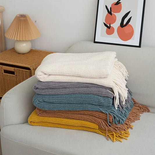 Knitted wool throw blanket with tassels by MANDOTOS INTERNATIONAL, cozy home decor and travel accessory in soft, warm fabric.