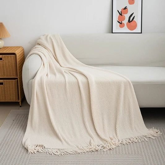 Knitted wool throw blanket with tassels from MANDOTOS INTERNATIONAL, cozy home decor and travel accessory in warm, soft fabric.