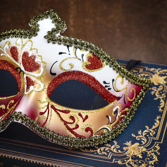 Men's glitter half face mask by MANDOTOS INTERNATIONAL, ideal for masquerade balls and Halloween costumes, featuring sparkling embellishments.