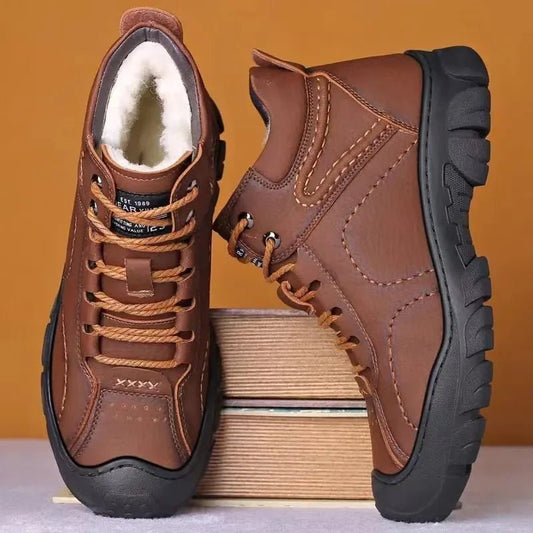 Men's waterproof winter ankle boots by MANDOTOS INTERNATIONAL with non-slip soles and sturdy work shoe design.