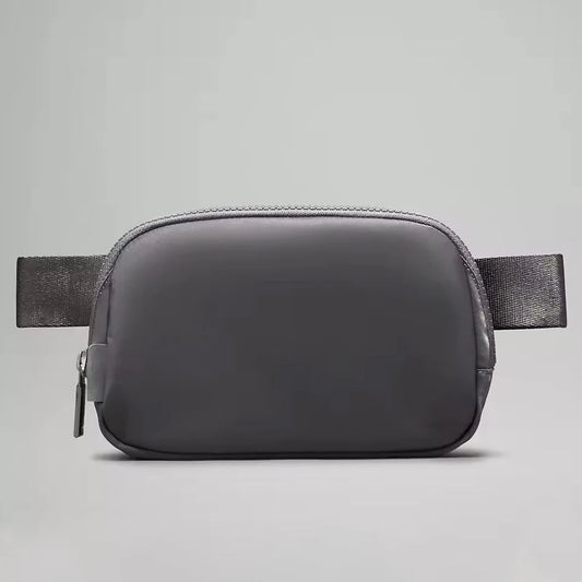Mandotos International premium lightweight women’s waist bag for running and travel, shown in black with adjustable strap.