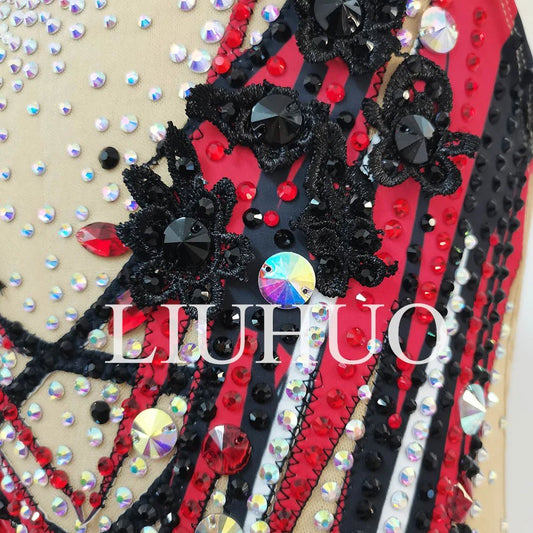 Red synchronized swimming team performance swimsuit by MANDOTOS INTERNATIONAL, featuring sleek design and flexible fit for competitive swimming.