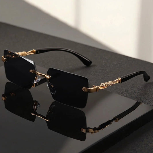 Unisex luxury frameless black and gold sunglasses with leopard print, UV400 protection, thin rectangular lenses, elegant design.
