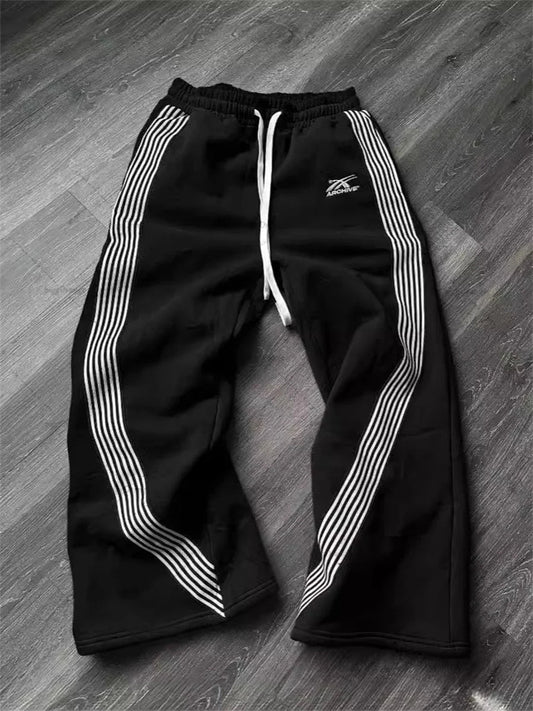 Y2k embroidered black and gray camouflage tactical jogger pants by MANDOTOS INTERNATIONAL, with drawstring waist and functional design.