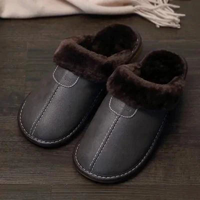 Men's luxury leather slippers by MANDOTOS, showcasing sleek design and soft leather material on a neutral background.