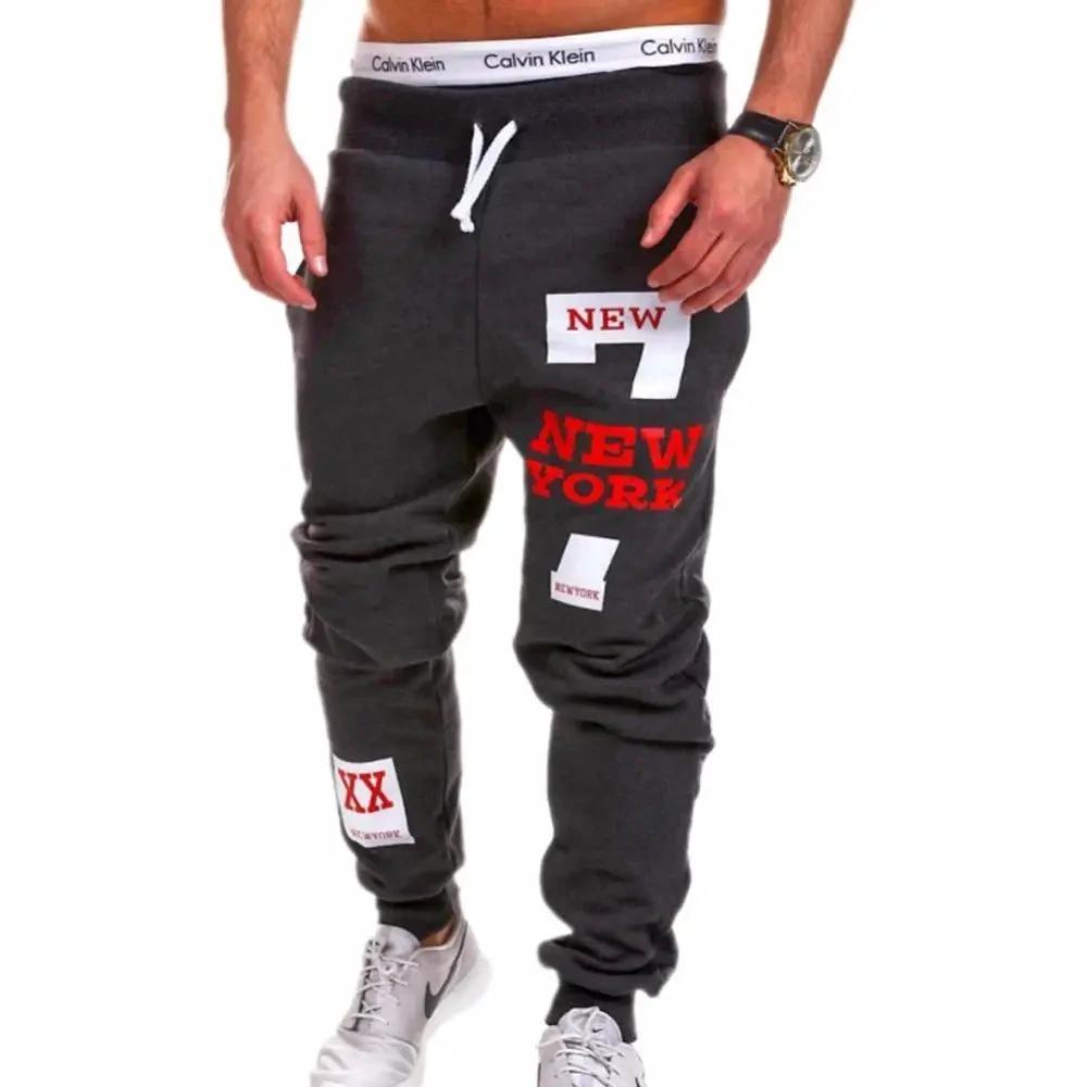 Mens black joggers by MANDOTOS, featuring a relaxed fit and elastic waistband, displayed on a neutral background.