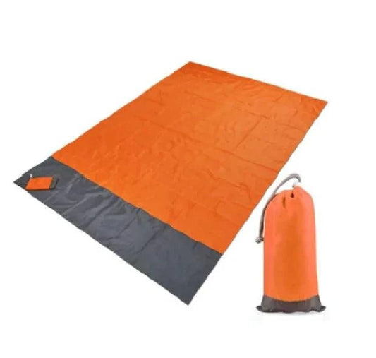 Mandotos sandproof portable beach mat spread on sandy shore, lightweight and easy to carry for outdoor relaxation.