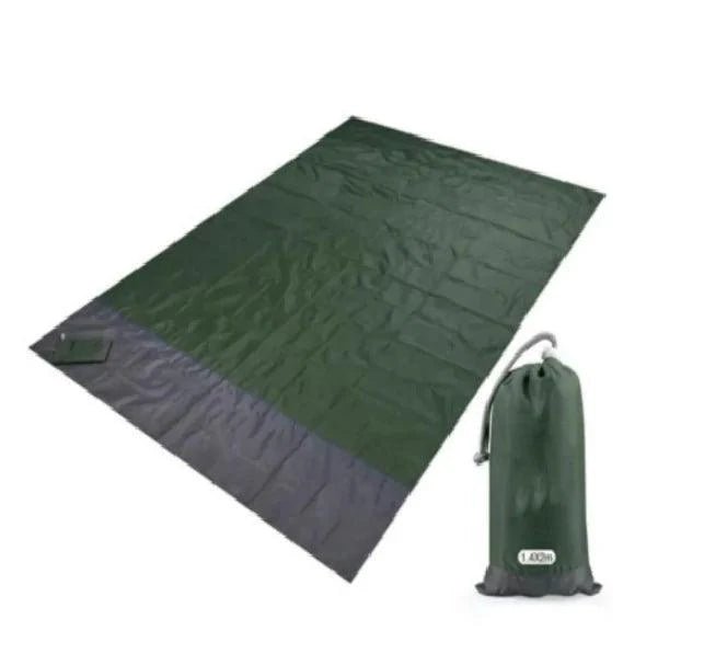 Mandotos sandproof portable beach mat spread out on sandy shore, lightweight and easy to carry for outdoor beach activities.
