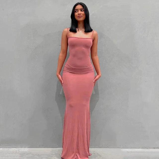 Mandotos sleek satin backless gown displayed on a mannequin, featuring a smooth, shiny fabric and elegant design.