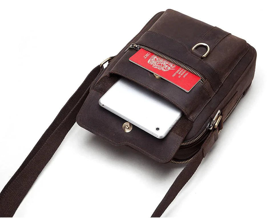 Vintage leather messenger bag by MANDOTOS with adjustable shoulder strap and multiple compartments for versatile carrying.