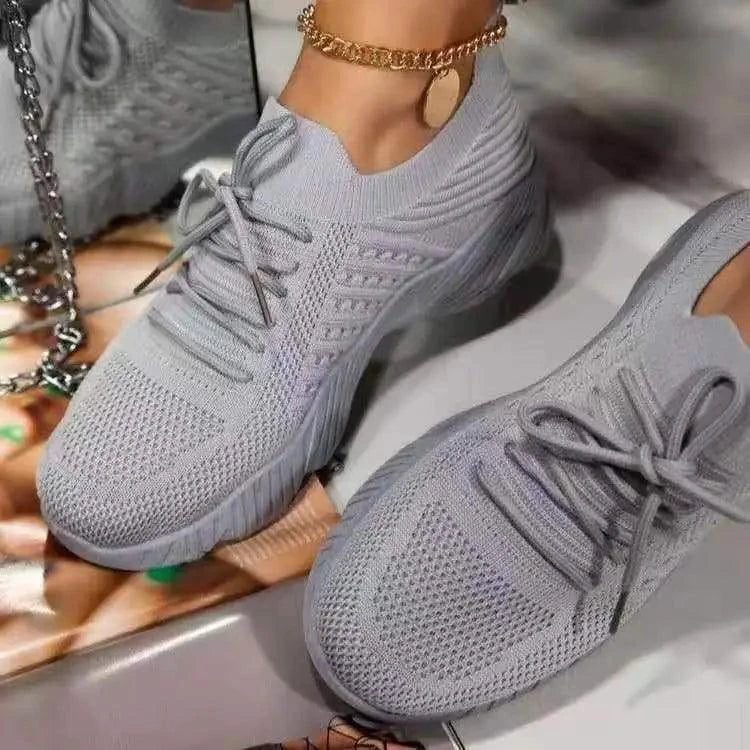 Mandotos walking shoes in black with white soles, featuring breathable mesh upper and cushioned sole for comfortable walking.