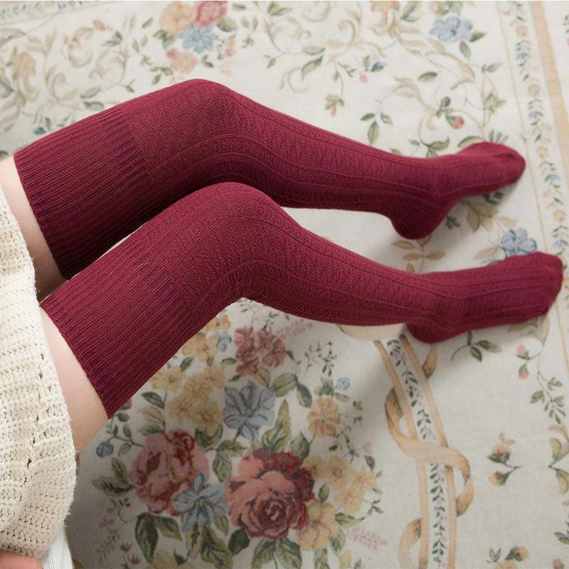 Women's solid color warm knee-high socks by MANDOTOS, featuring a cozy and stylish design for cold weather.