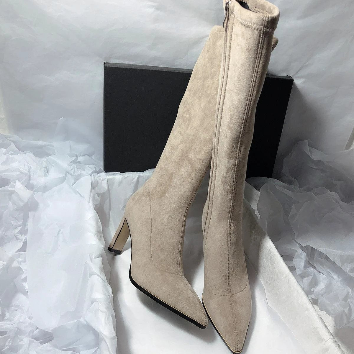 Women's high heel stretch below-the-knee boots by MANDOTOS, showcasing sleek black leather with pointed toes and stiletto heels.