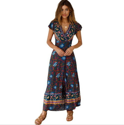 Tropical Bloom Maxi Dress by Mandotos International featuring a colorful floral pattern and flowing fabric.