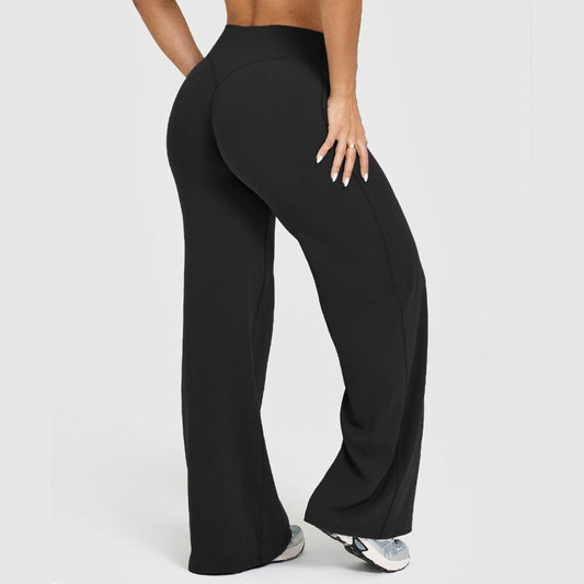 Women's black straight-leg yoga pants, full-length athletic trousers with slight flare.