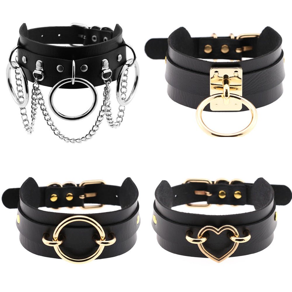 Set of four black leather chokers with gold-tone and silver-tone hardware, rings and a heart charm