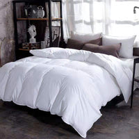 White goose-down winter duvet on a bed with brown pillows in a modern bedroom by Ancient Energy