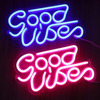 Led transparent backboard neon light sign reading Good Vibes in blue and pink; Ancient Energy wall-hanging decor.