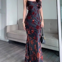 Flocked Strappy Maxi Dress by Ancient Energy in black with red floral flocked pattern, floor-length silhouette.