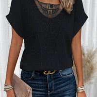 Summer hollow-out short-sleeve black top with intricate crochet pattern, paired with denim jeans