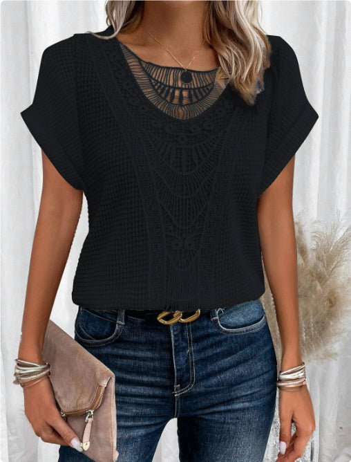 Summer hollow-out short-sleeve black top with intricate crochet pattern, paired with denim jeans