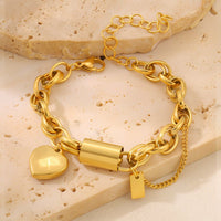Ancient Energy gold-tone bracelet with heart pendant on a chunky chain and small tag charm