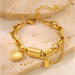 Ancient Energy gold-tone bracelet with heart pendant on a chunky chain and small tag charm