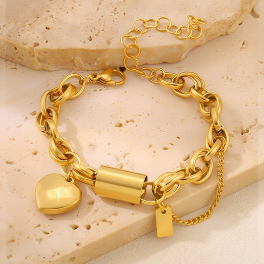 Versatile Titanium Bracelet With A Heart-shaped Pendant in gold-tone metal, with chunky linked chain and clasp.