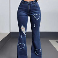Denim jeans for women with distressed patches and heart-shaped frayed patches on both legs, dark wash bootcut.