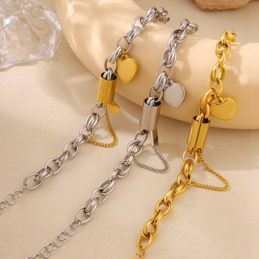 Titanium bracelet with heart pendant, set of 3 silver and gold-toned chains