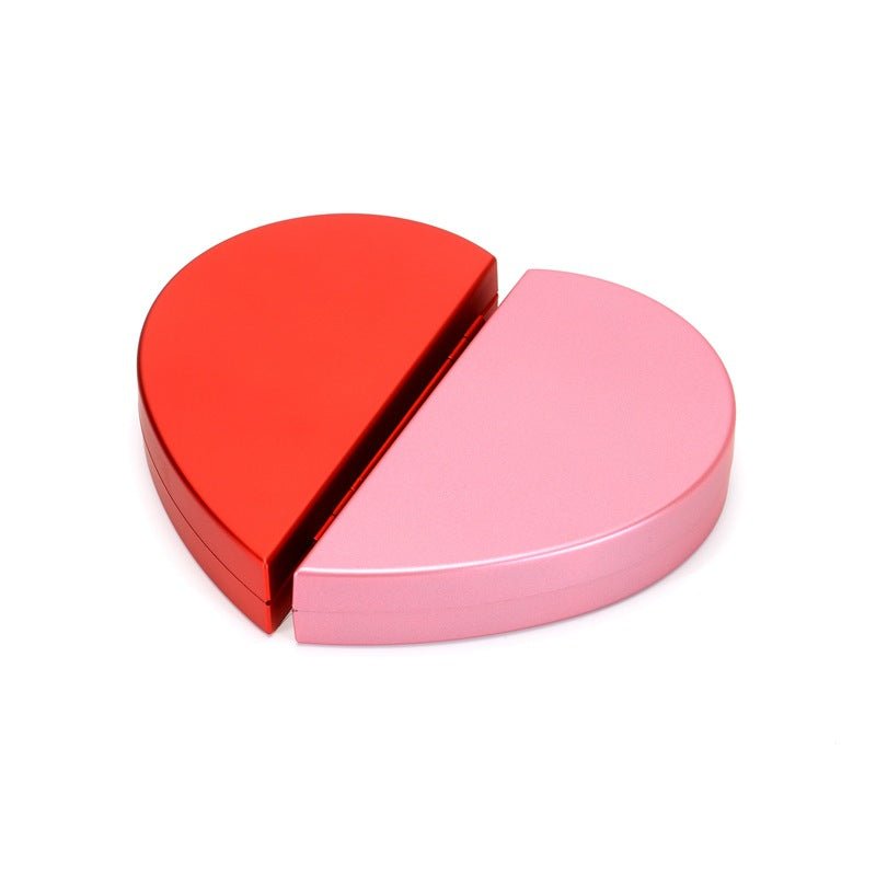 Heart-shaped rotating ring box in red and pink metal halves