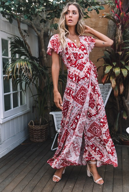 Mandotos International Tropical Bloom Maxi Dress featuring vibrant floral patterns and flowing fabric on a model.